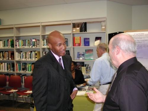 Rodrick speaking with faculty after college presentation
