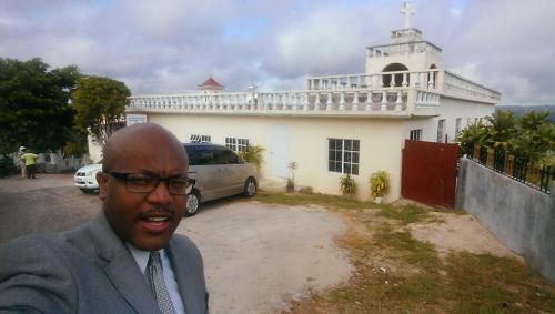 Rodrick Walters in front of Full Truth Church of God Deliverance Centre at Santa Hill