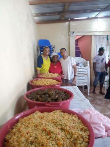 Prophet Rohan Rambally and staff with meal prepared for orphans